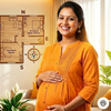 A smiling pregnant woman in an orange maternity outfit standing next to a Vastu Shastra home plan and compass, representing healthy pregnancy and spatial energy balance