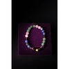 Multicolored beaded bracelet on a purple velvet surface with 'Shubh' branding.