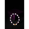 Bracelet with white, purple, and gold beads on a dark background