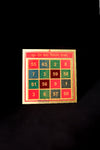 A colorful square-shaped religious item with Hindi text and numbers from 0 to 99, indicative of a spiritual protection design.