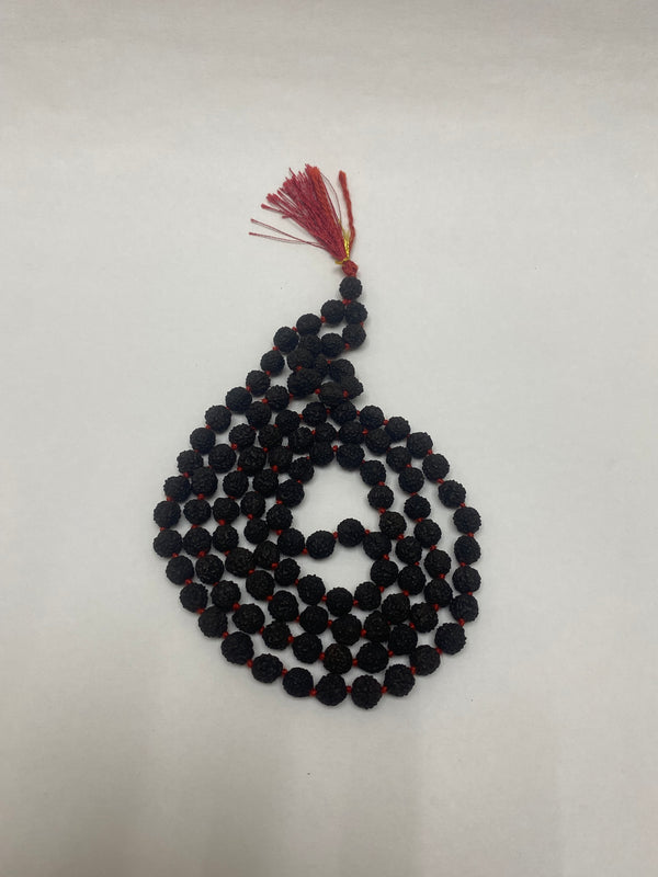 A traditional 108-bead Black Rudraksha Mala with a red silk tassel