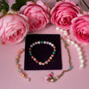 Jewelry set with pink roses on a pink background