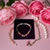 Jewelry set with pink roses on a pink background