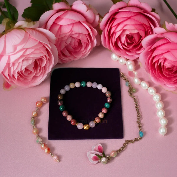 Jewelry set with pink roses on a pink background