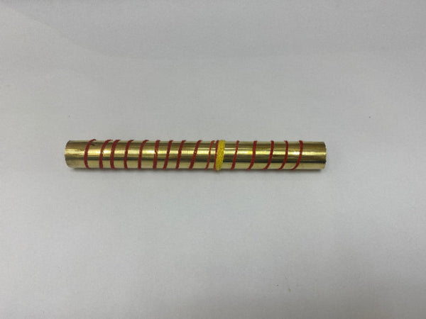 Gold cylindrical object with red string wrapping on a white background
