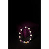Beaded bracelet with purple, white, and gold beads on a dark background