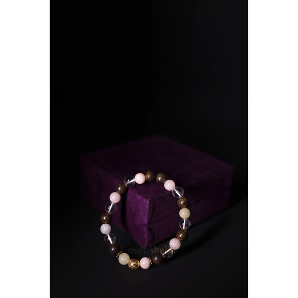 Beaded bracelet on a dark background with a purple box
