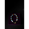 Beaded bracelet on a purple velvet stand with 'mahashri' branding against a dark background