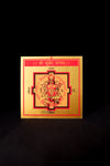 A colorful Shri Kuber Yantra poster with geometric designs and Sanskrit script on a dark background.