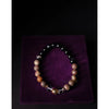 Beaded bracelet on a purple velvet surface with a dark background