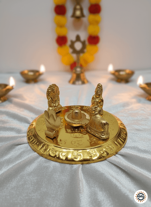 Golden Hindu puja thali with deities Lord Shiva, Parvati, and Ganesha, lit oil lamps, and floral decorations