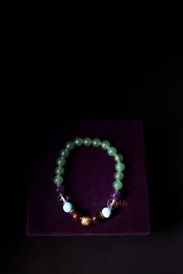Beaded bracelet on a purple stand with a dark background
