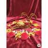 Golden Om diya lamp on red velvet with arranged red rose, yellow and white flower petals
