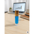 Blue rollerball bottle with gold cap on a desk next to a laptop and notebook.