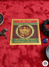 Vedic astrology chart on a red fabric background with spiritual items.