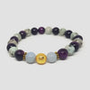 Beaded bracelet with purple, white, and gold beads on a white background