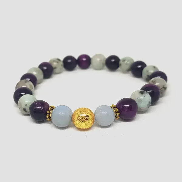 Beaded bracelet with purple, white, and gold beads on a white background