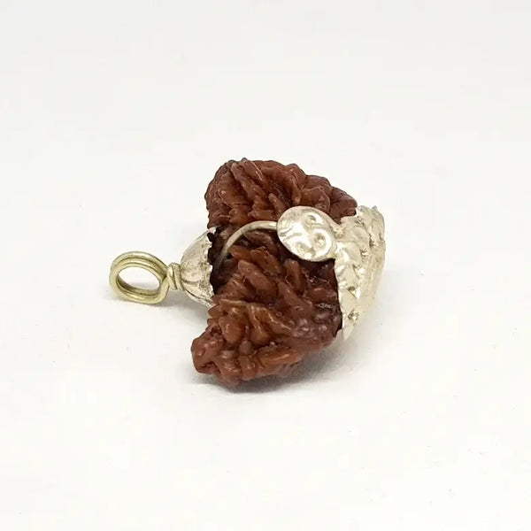 A rare, nearly spherical 1 Mukhi Rudraksha bead with one continuous vertical groove running from top to bottom. The surface is densely packed with natural 'thorny' protrusions characteristic of high-quality Himalayan beads