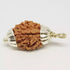 A round 3 Mukhi Rudraksha bead featuring three clear, vertical natural grooves. The bead has a robust, woody texture with deep brown ridges and a naturally occurring hole through the center