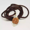 A 3 Mukhi Rudraksha bead suspended as a pendant on a gold chain. The image highlights the three symmetrical clefts on the bead’s surface and its rich, earthy color