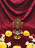 Bronze lamp with decorative flowers on a red fabric background