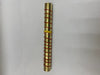 Brass cylindrical object with red bands on a white background