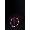 Beaded bracelet on a dark background with a purple box