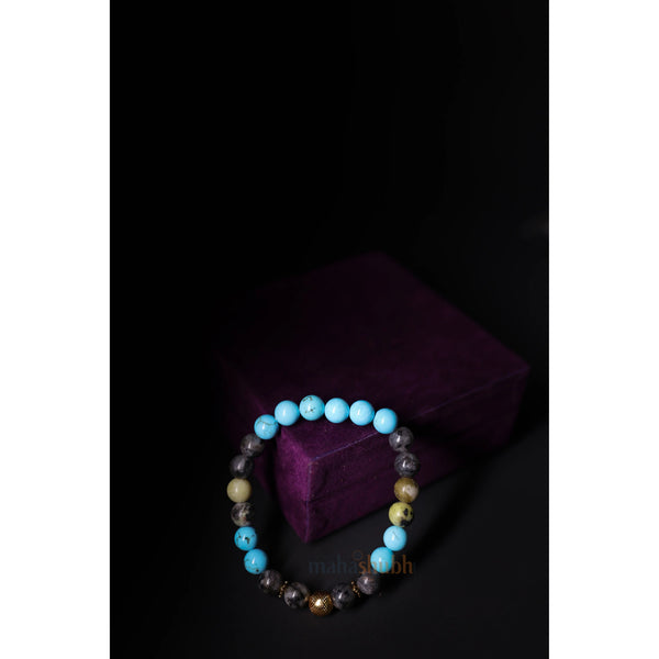 Multicolored beaded bracelet on a dark background with a purple fabric