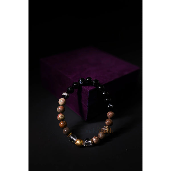 Beaded bracelet on a dark surface with a purple fabric background