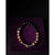 Beaded bracelet on a purple velvet surface with a dark background