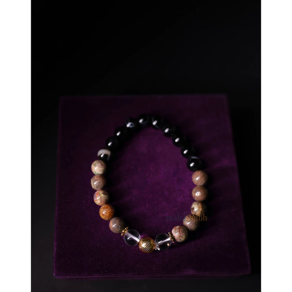 Beaded bracelet on a purple velvet surface with a dark background
