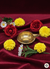 Brass diya oil lamp surrounded by red roses, yellow marigolds, and white daisies on red velvet fabric