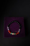 Beaded bracelet on a purple square with a black background