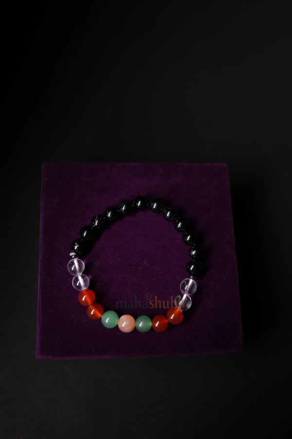 Beaded bracelet on a purple square with a black background