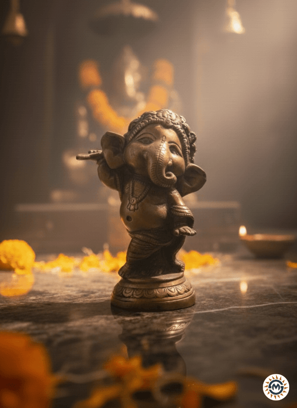 Antique finish Bala Ganpati brass idol for home decor, featuring the child Ganesha in a sitting posture holding a mango, handcrafted brass murti for pooja room.