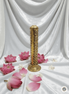 Decorative brass incense burner with pink lotus flowers on a white fabric background
