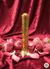 Gold decorative vase with pink flowers on a red fabric background