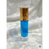 Blue perfume bottle with gold cap on a white textured background