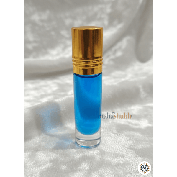 Blue perfume bottle with gold cap on a white textured background
