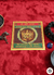 Vedic astrology chart on a red fabric background with spiritual items.